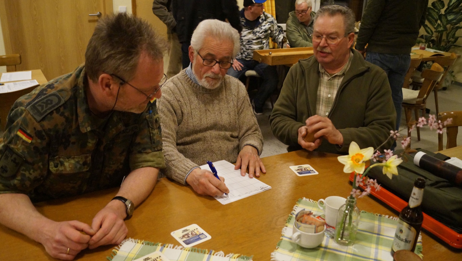 Bild 2 Beim Preisknobeln gab es kulinarische Preise zu gewinnen. (von links) Stabsfeldwebel Jens Schumacher, Feldwebel für Reservisten des Landeskommando Niedersachsen, Oberfeldwebel d.R. Reinhard Mikulla, Vorsitzender der RK Westerstede, und Hauptfeldwebel d.r. Volkert Suhren, Vorsitzender der Kreisgruppe Wilhelmshaven des Reservistenverbandes.